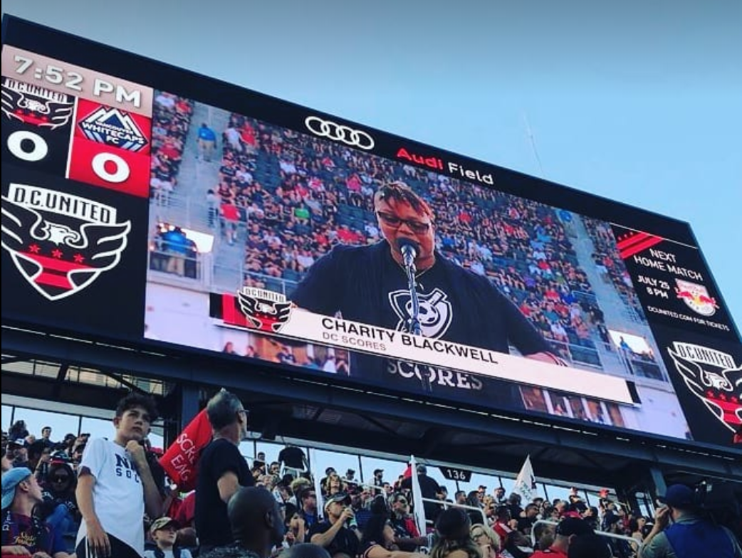 Charity Blackwell performs an original poem before kick-off at Audi Field's opening match.